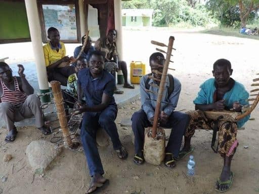 Musicians from the Mubaku community group playing local instruments near the ferry launch.